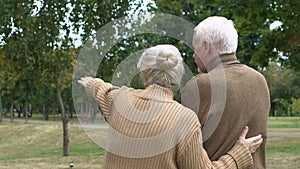 Back view mature couple planning building of country house, dreams, slow-motion