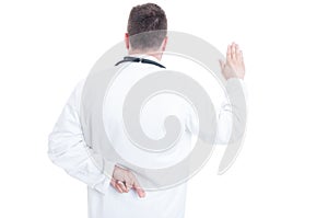 Back view of medic or doctor lying about Hippocratic oath