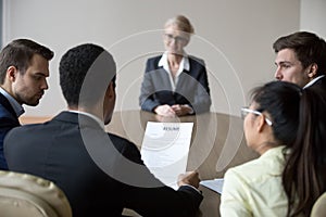 Back view of millennial employers consider candidate resume