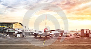 Back view of modern airplane at terminal gate ready for takeoff