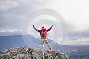 Back view, mountain and man with celebration for hiking, peak and journey with success and freedom outdoor. Trekking