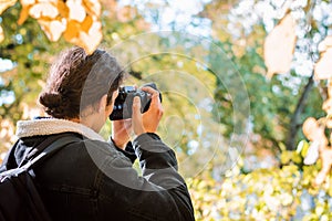 Back view of a nature and wildlife photographer in the forest