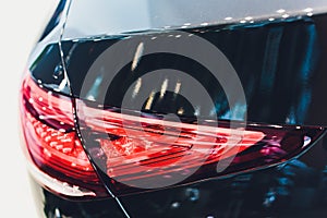 Back view of new black car. Closeup headlights of car. Black premium city crossover, luxury SUV rear light closeup. Car