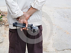 Back view of old man holding a action camera