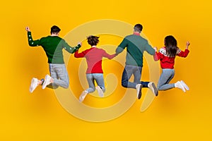 Back view photo of four people buddies jumping enjoying x mas christmas festive offers isolated bright color background