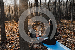 Back view photo of the healthy young brunette woman in sportswear, lifestyle balanced practicing meditate and zen energy