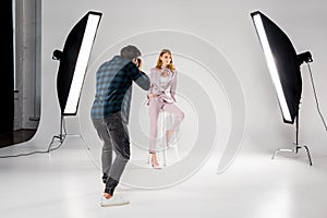 back view of photographer shooting beautiful young female model