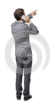 Back view of pointing business man in suit  talking on mobile phone