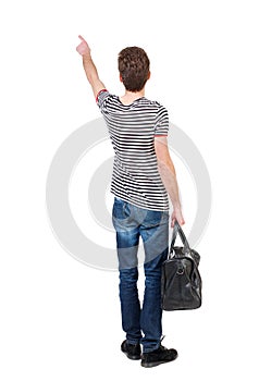 Back view of pointing man with bag.