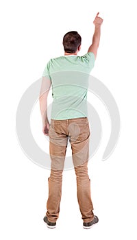 Back view of pointing man in shirt and jeans.