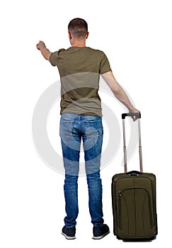 Back view of pointing man with suitcase