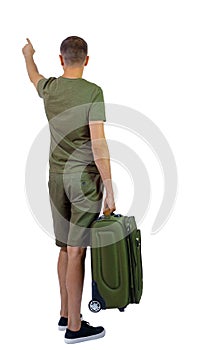 Back view of pointing man with suitcase