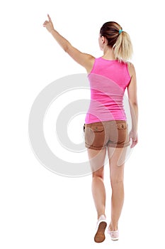 Back view of pointing walking woman