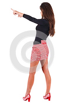 Back view of pointing woman.