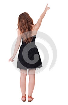 Back view of pointing woman.