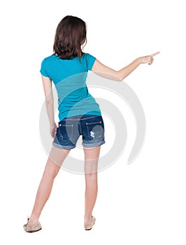 Back view of pointing woman.