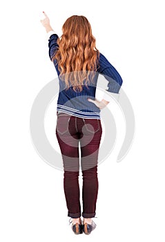 Back view of pointing woman.