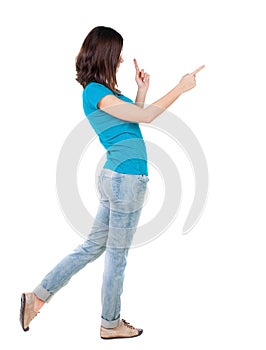 Back view of pointing woman.