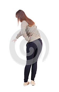 Back view of pointing woman.