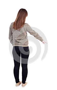 Back view of pointing woman.