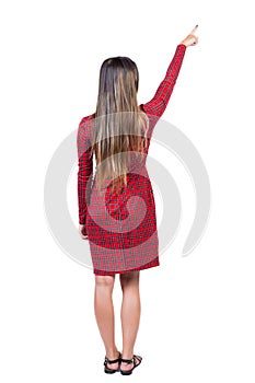 Back view of pointing woman. beautiful girl.