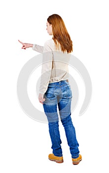 Back view of pointing woman. beautiful girl.