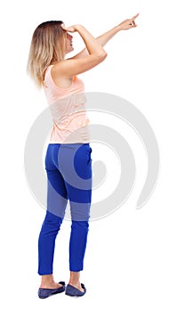 Back view of pointing woman. beautiful girl.