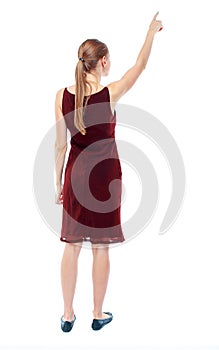 Back view of pointing woman. beautiful girl.