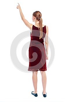 Back view of pointing woman. beautiful girl.