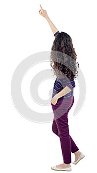 Back view of pointing woman. beautiful girl.