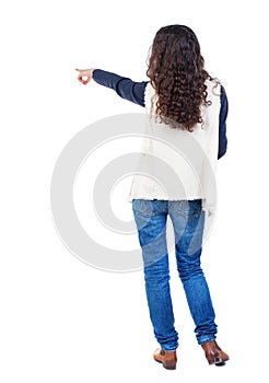 Back view of pointing woman. beautiful girl.