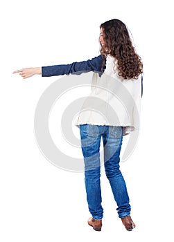 Back view of pointing woman. beautiful girl.