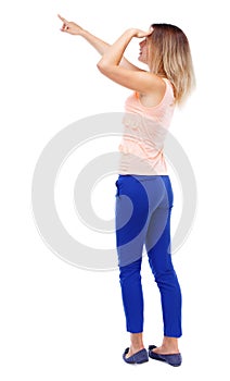 Back view of pointing woman. beautiful girl.