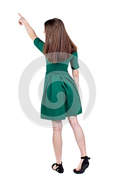 Back view of pointing woman. beautiful girl.