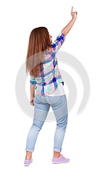 Back view of pointing woman. beautiful redhead girl in jeans.