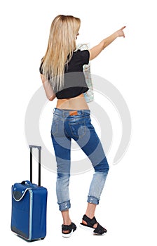 Back view of a pointing woman with a map and a suitcase