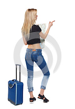 Back view of a pointing woman with a map and a suitcase