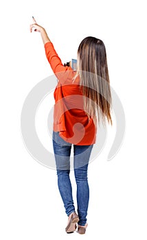 Back view pointing woman with a stack of books.