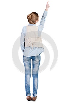 Back view of pointing woman in vest.