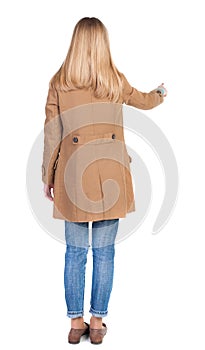 Back view of pointing womanin brown cloak.