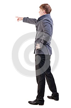 Back view of pointing young business men in coat