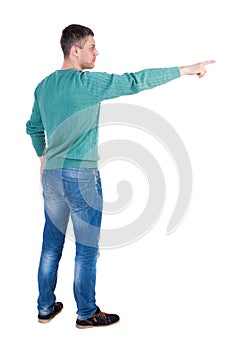 Back view of pointing young men in jeans.