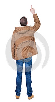 Back view of pointing young men in parka.