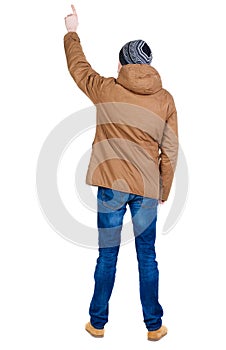 Back view of pointing young men in parka.