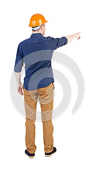 Back view of pointing young men in shirt and helmet.