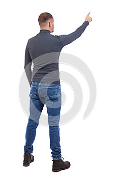 Back view of pointing young men in shirt and jeans.