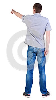 Back view of pointing young men in shirt and jeans