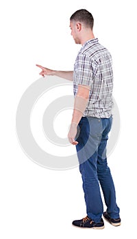 Back view of pointing young men in shirt and jeans.