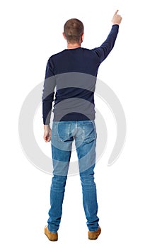 Back view of pointing young men in shirt and jeans.