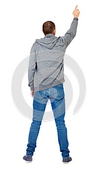 Back view of pointing young men in shirt and jeans.